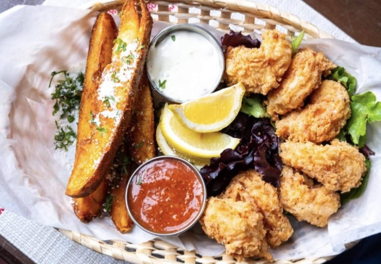 Fried fish basket with potato wedges and dipping sauces