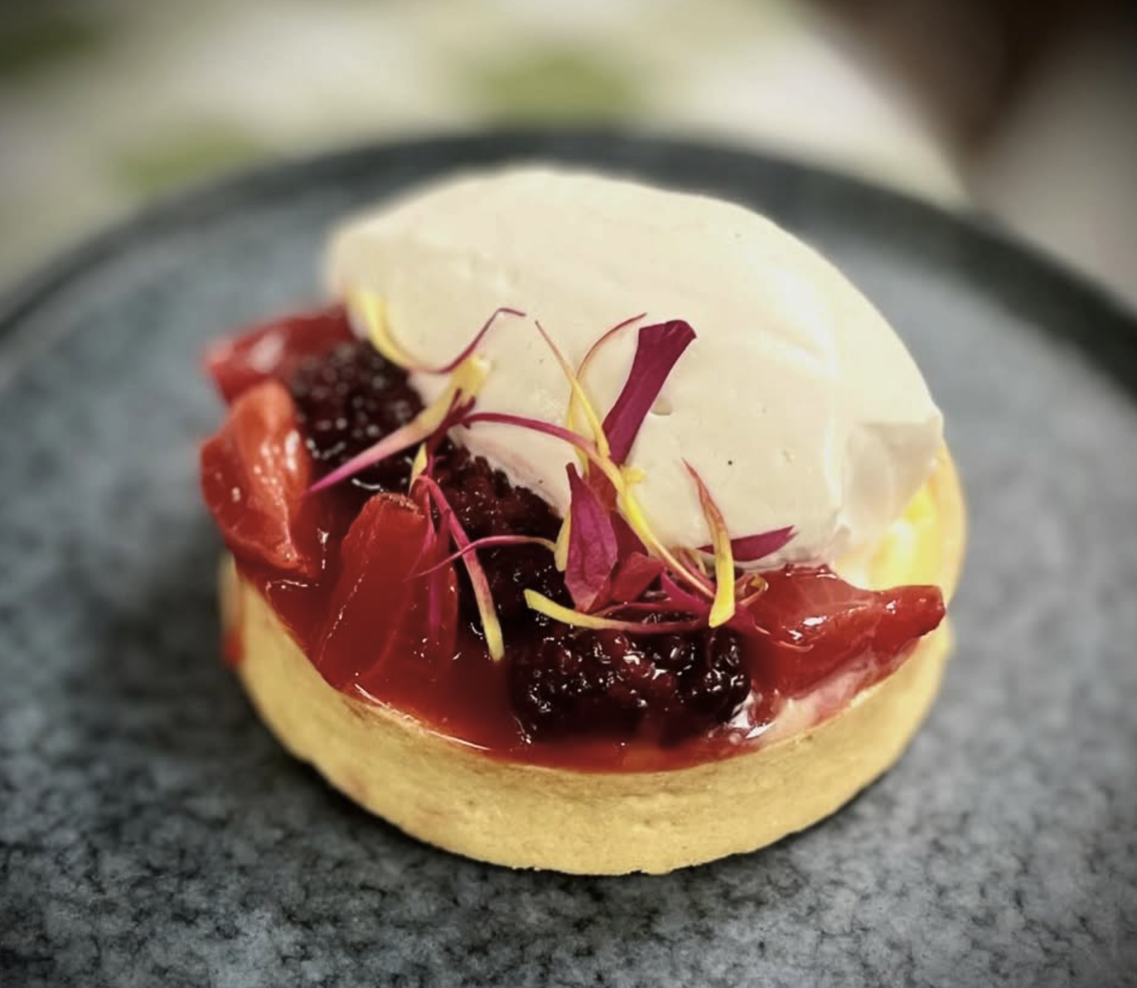 Lemon tart with stewed berries and cream